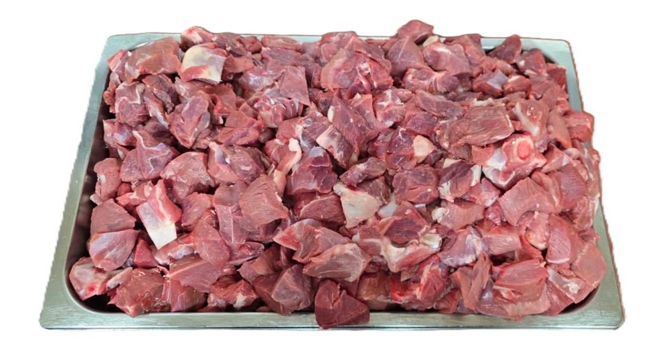Fresh lamb curry pieces in a butcher's tray