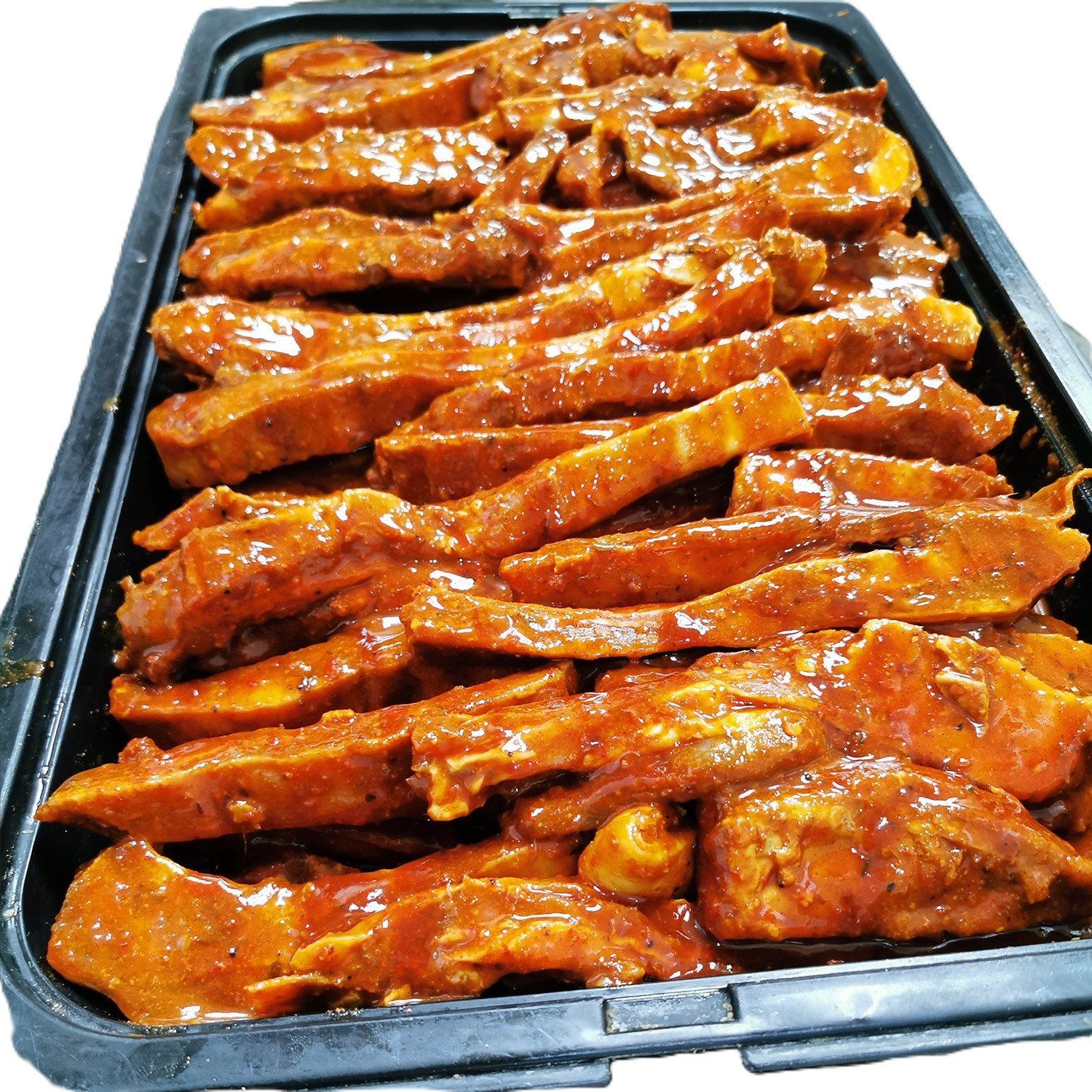 Marinated chicken breasts in a butcher's tray